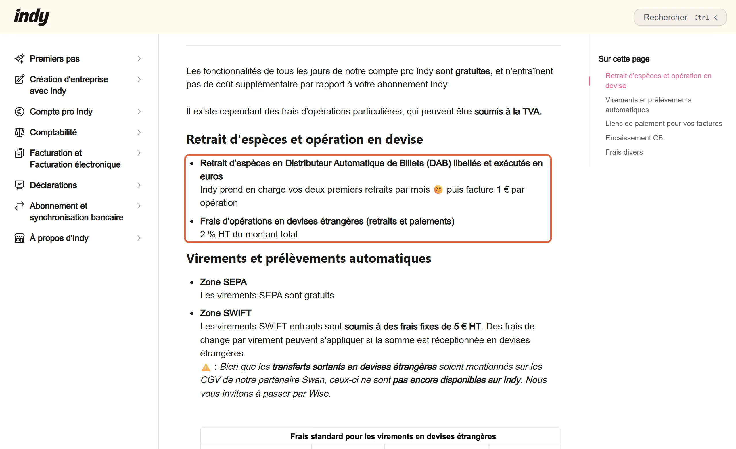 Article du centre d'aide d'Indy sur les frais d'opérations particulières du compte pro, avec la section Retrait d'espèces et opération en devise encadrée : deux retraits par mois pris en charge puis 1 € par opération, 2 % HT du montant pour les opérations en devises étrangères